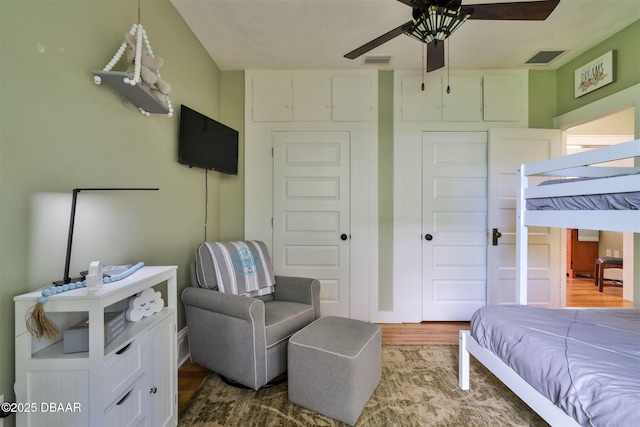 bedroom featuring wood finished floors, visible vents, a closet, and ceiling fan