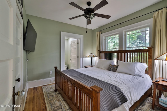 bedroom with baseboards, wood finished floors, and a ceiling fan