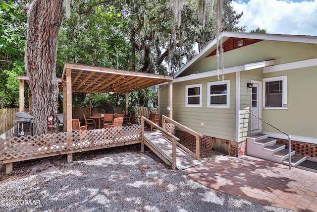 view of patio / terrace with fence, a wooden deck, a pergola, entry steps, and an outdoor hangout area