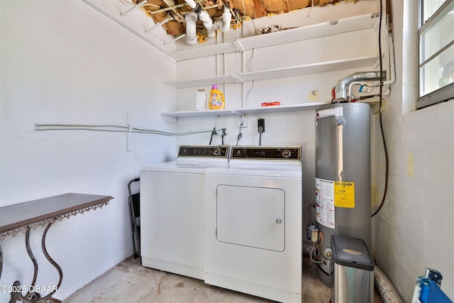 washroom with water heater, laundry area, and washing machine and dryer