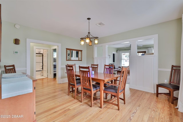 dining room featuring light wood finished floors and visible vents