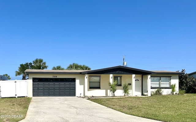 view of front of home with a gate, driveway, a front yard, a garage, and fence