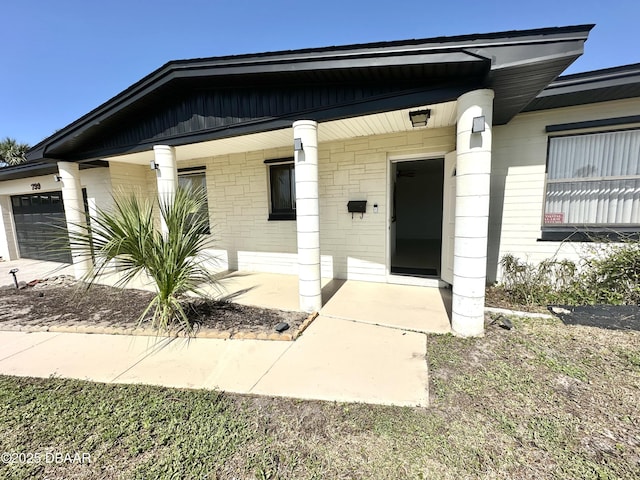 bungalow-style home with a garage and covered porch