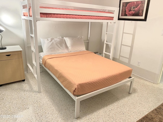 bedroom with light speckled floor