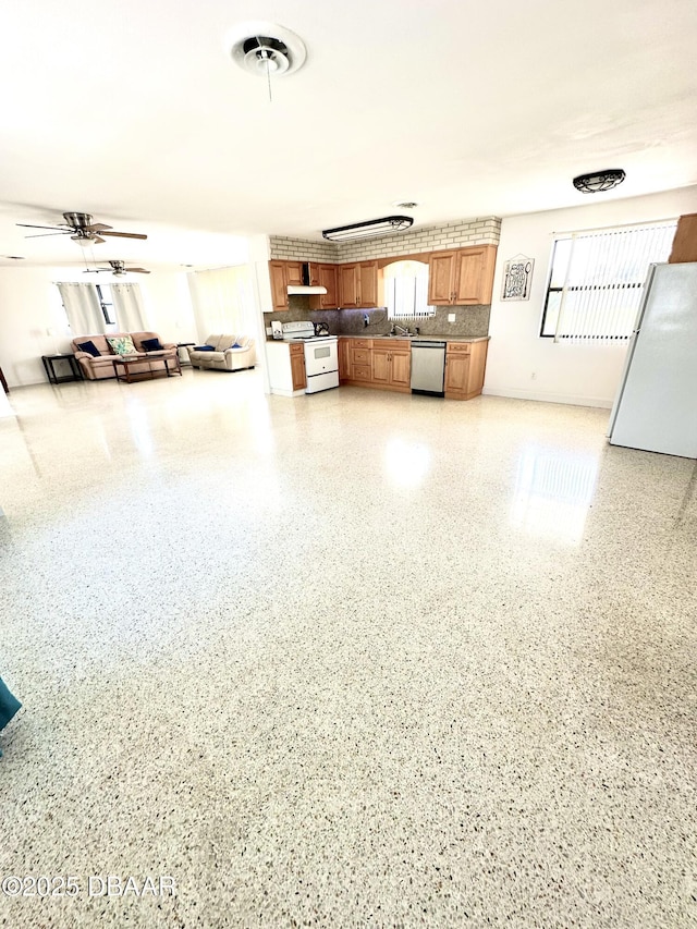 interior space featuring visible vents, a sink, freestanding refrigerator, and a ceiling fan