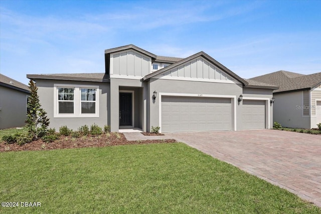 view of front of home with a garage and a front yard