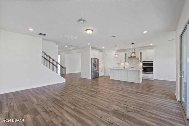 unfurnished living room with dark hardwood / wood-style floors and sink