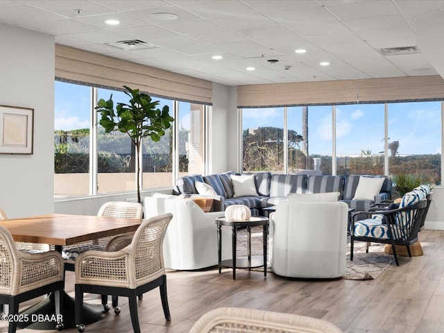 interior space featuring visible vents, a healthy amount of sunlight, and a paneled ceiling