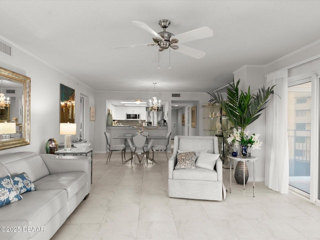 living room featuring visible vents, ornamental molding, and ceiling fan with notable chandelier