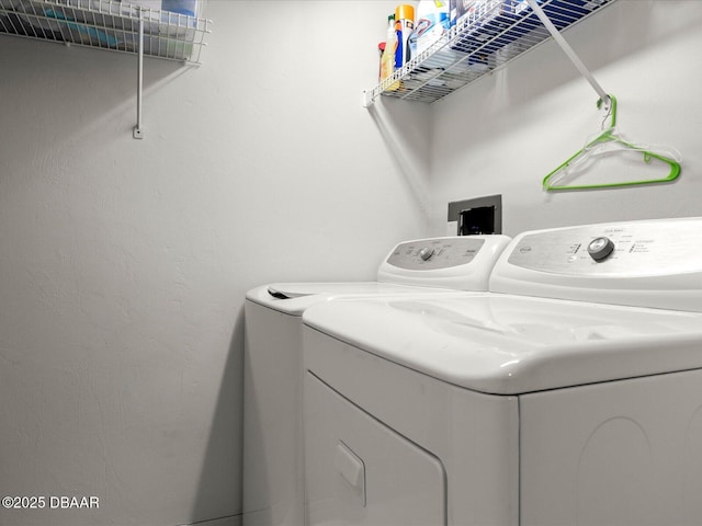 laundry area featuring separate washer and dryer and laundry area