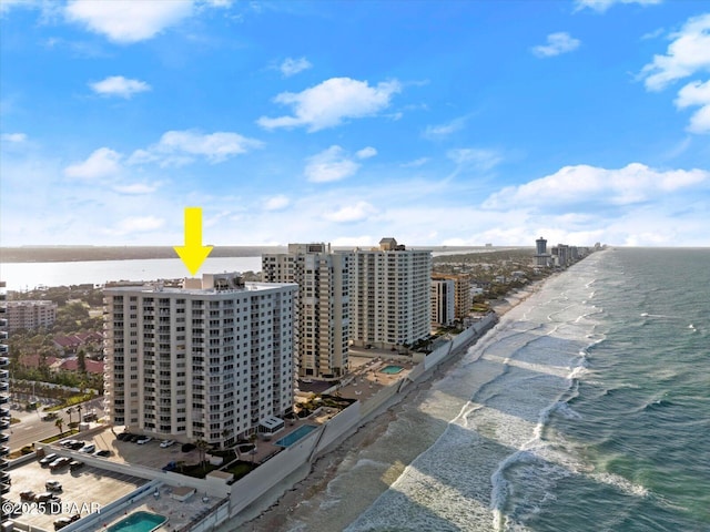 birds eye view of property with a view of city, a water view, and a beach view