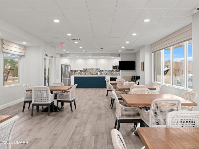 dining room with recessed lighting, baseboards, visible vents, and light wood-type flooring