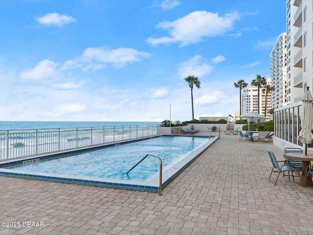pool featuring fence and a patio area