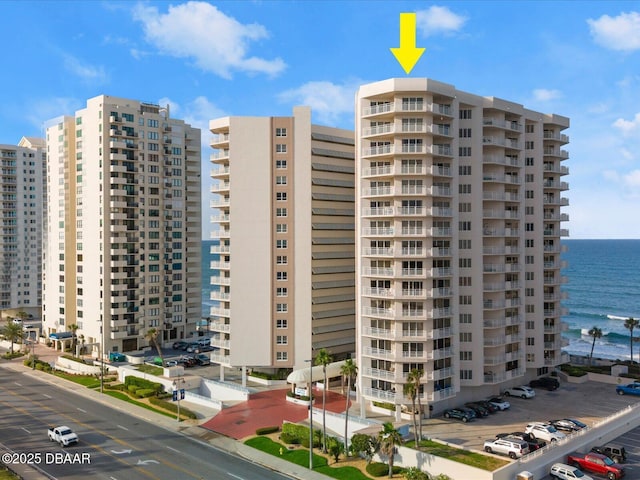 view of building exterior featuring a view of city and a water view