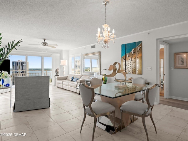 dining space with visible vents, a textured ceiling, a water view, ceiling fan with notable chandelier, and light tile patterned floors