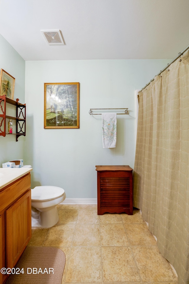 bathroom with tile patterned flooring, vanity, toilet, and curtained shower