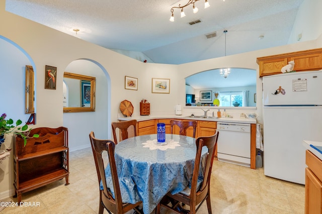 129 Rae Dr, Palm Coast, FL 32164 - dining room with arched walkways, vaulted ceiling, a chandelier, and a textured ceiling