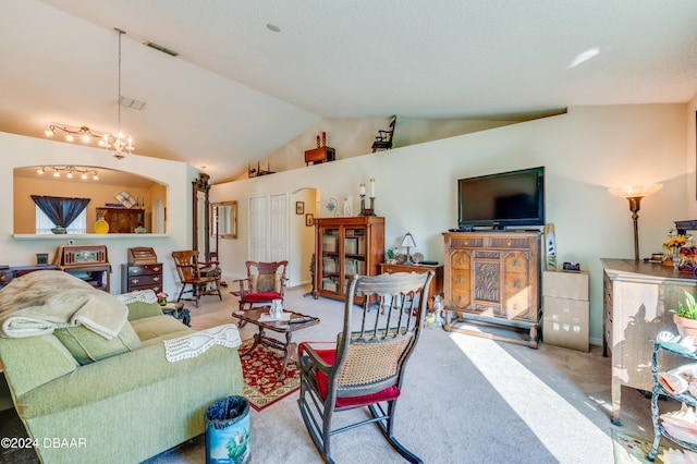 129 Rae Dr, Palm Coast, FL 32164 - carpeted living area with vaulted ceiling and a chandelier
