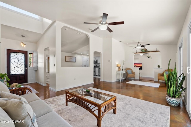 living room featuring ceiling fan and lofted ceiling