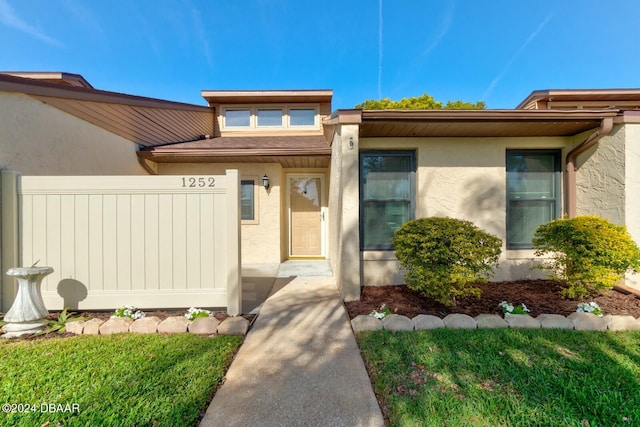 property entrance with a yard