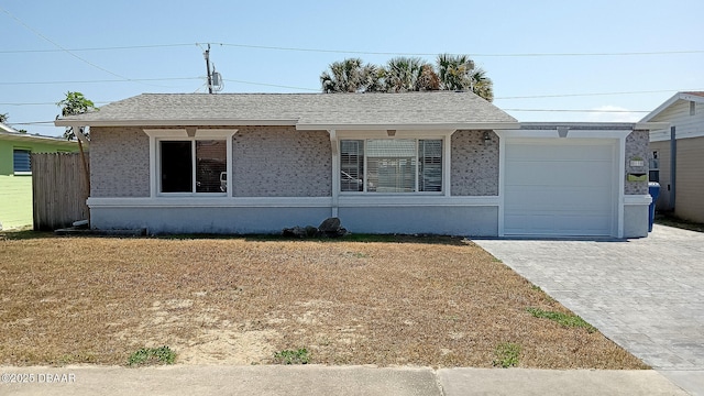 59 Margaret Rd, Ormond Beach, FL 32176 - ranch-style house featuring fence, decorative driveway, a garage, a front yard, and roof with shingles