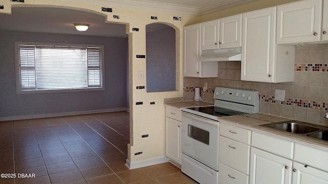 59 Margaret Rd, Ormond Beach, FL 32176 - kitchen featuring under cabinet range hood, arched walkways, white electric range oven, tile patterned floors, and backsplash