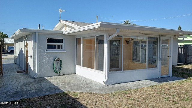 59 Margaret Rd, Ormond Beach, FL 32176 - rear view of house featuring central air condition unit, brick siding, a yard, a fenced backyard, and a sunroom