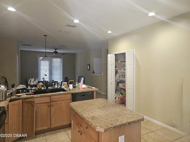 kitchen featuring light tile patterned floors, a ceiling fan, visible vents, a kitchen island, and black appliances