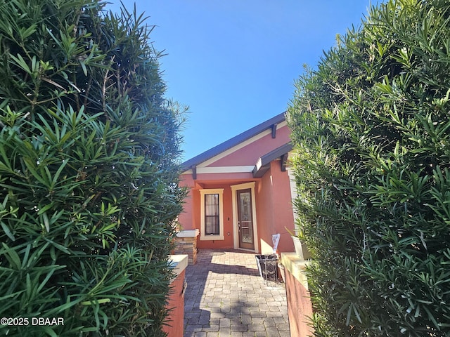 property entrance with stucco siding