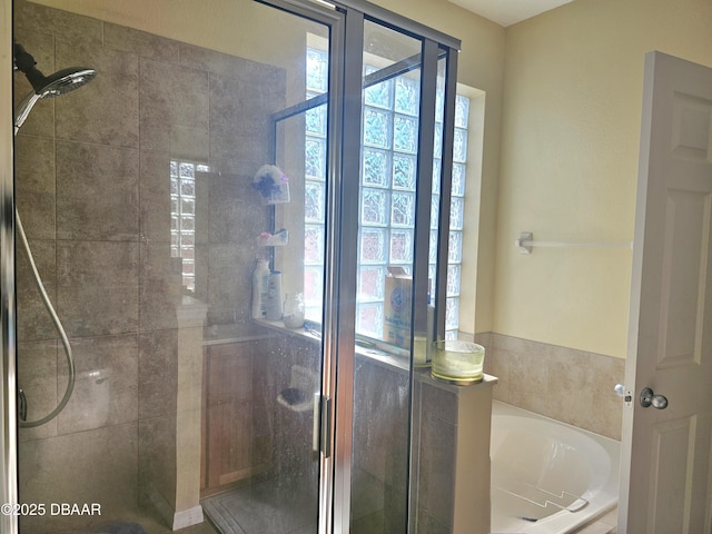 bathroom with a shower stall and a garden tub