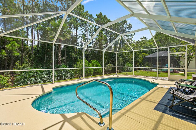 view of pool featuring a lanai and a patio area