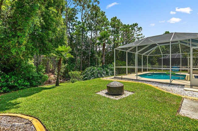 view of yard featuring glass enclosure and a patio