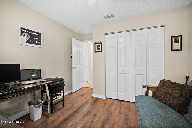 office area featuring a textured ceiling and dark hardwood / wood-style floors