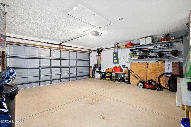 garage featuring electric panel and a garage door opener