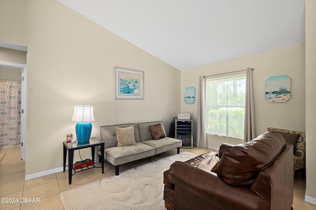 tiled living room with a textured ceiling and vaulted ceiling