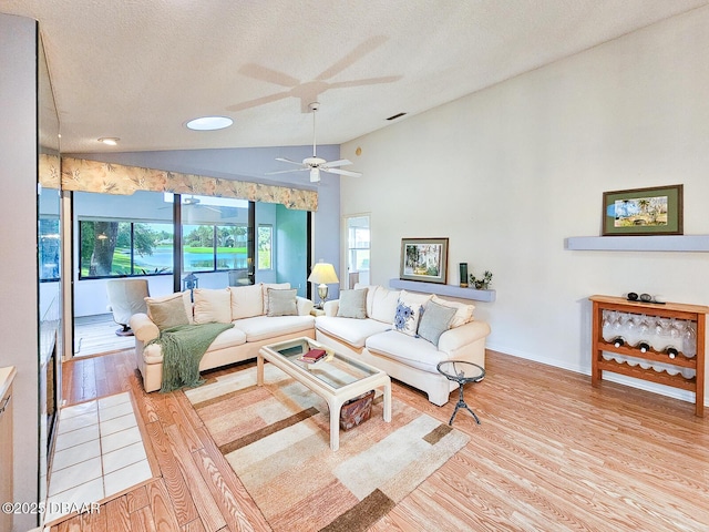 900 Smokerise Blvd, Port Orange, FL 32127 - living area featuring lofted ceiling, ceiling fan, light wood-style floors, a textured ceiling, and baseboards