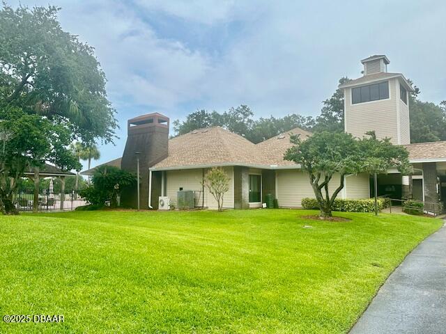900 Smokerise Blvd, Port Orange, FL 32127 - rear view of house featuring a chimney and a yard