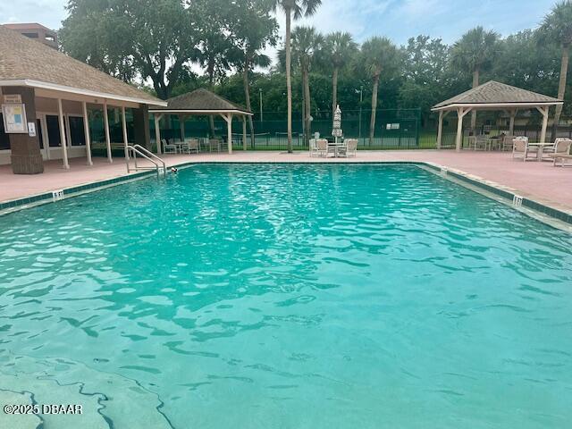 900 Smokerise Blvd, Port Orange, FL 32127 - community pool featuring a gazebo, a patio, and view of scattered trees
