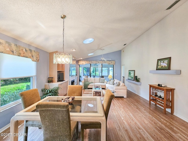 900 Smokerise Blvd, Port Orange, FL 32127 - dining room with wood finished floors, lofted ceiling, a textured ceiling, baseboards, and a chandelier
