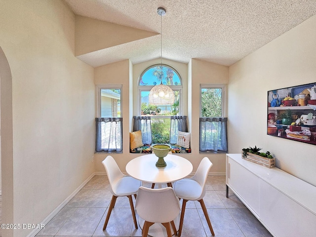 900 Smokerise Blvd, Port Orange, FL 32127 - dining area with vaulted ceiling, a chandelier, light tile patterned flooring, a textured ceiling, and arched walkways
