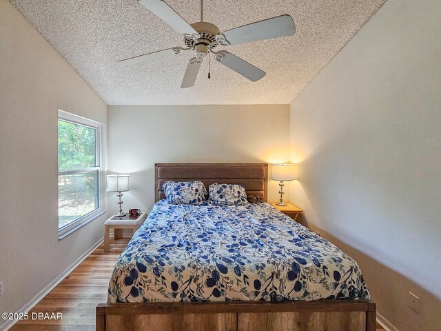 900 Smokerise Blvd, Port Orange, FL 32127 - bedroom with a textured ceiling, light wood-style flooring, baseboards, lofted ceiling, and ceiling fan