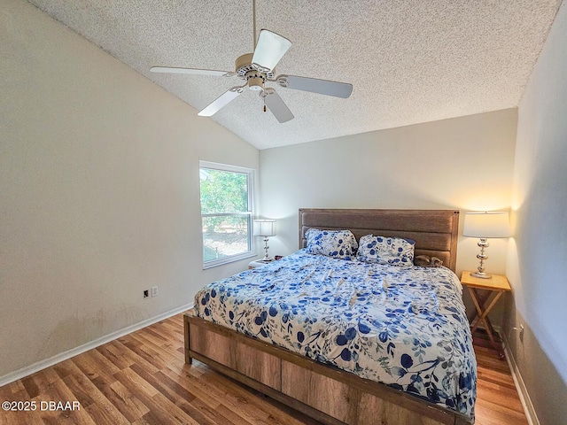 900 Smokerise Blvd, Port Orange, FL 32127 - bedroom with wood finished floors, a textured ceiling, vaulted ceiling, baseboards, and ceiling fan