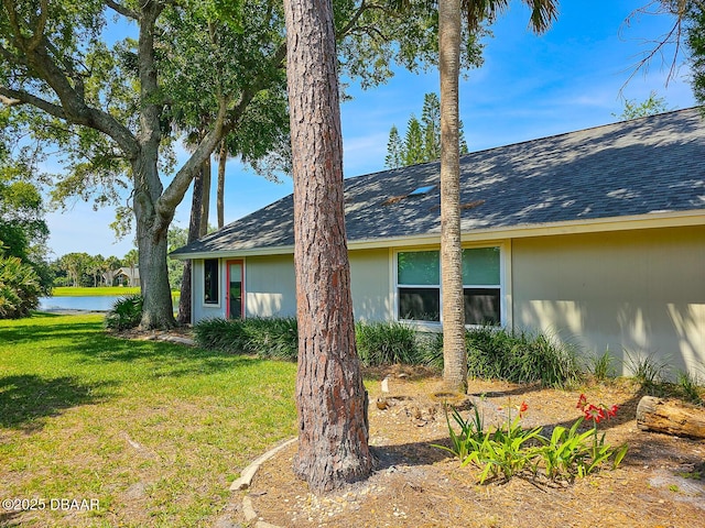 900 Smokerise Blvd, Port Orange, FL 32127 - view of side of home featuring a water view, a yard, and a shingled roof