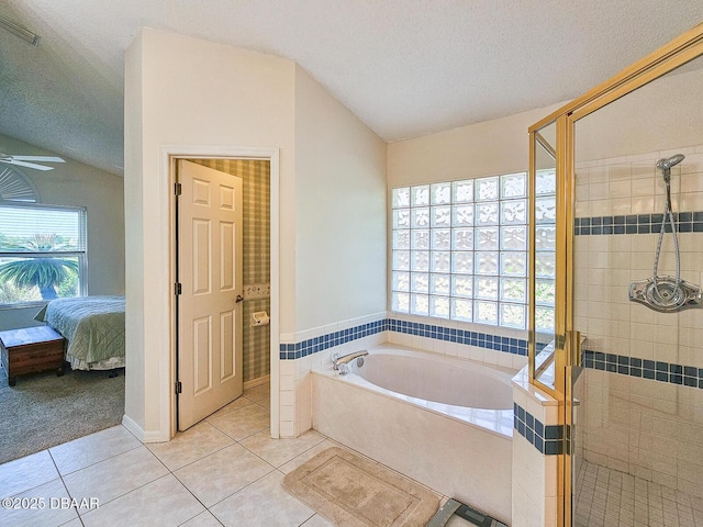 900 Smokerise Blvd, Port Orange, FL 32127 - bathroom with vaulted ceiling, tile patterned floors, a garden tub, a stall shower, and ensuite bathroom
