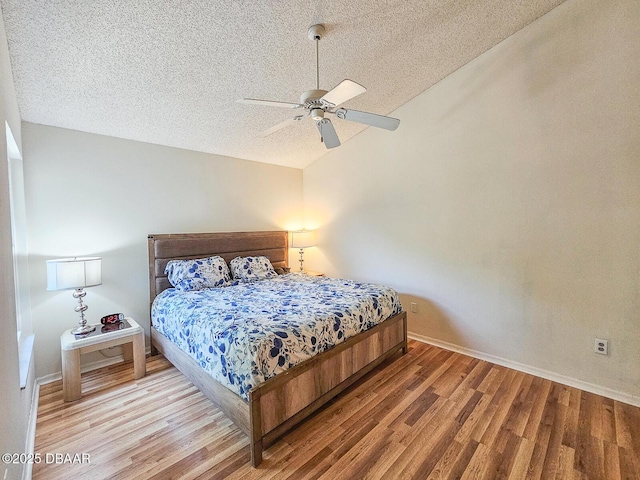 900 Smokerise Blvd, Port Orange, FL 32127 - bedroom with a textured ceiling, wood finished floors, baseboards, lofted ceiling, and a ceiling fan