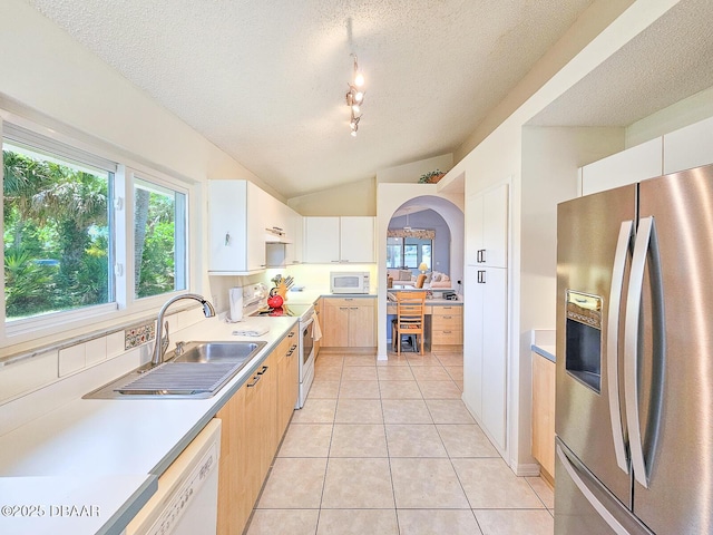 900 Smokerise Blvd, Port Orange, FL 32127 - kitchen featuring white appliances, a sink, lofted ceiling, a textured ceiling, and light tile patterned floors