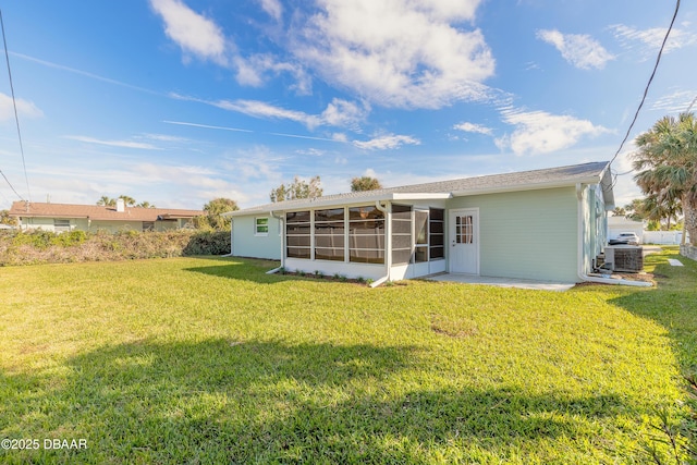 back of house with a sunroom, a patio area, central AC, and a yard