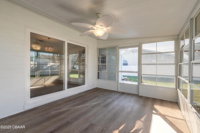 unfurnished sunroom with a ceiling fan and wooden ceiling