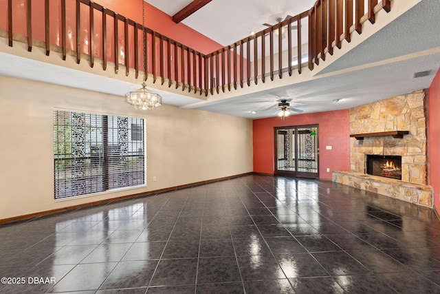 unfurnished living room featuring tile patterned flooring, a stone fireplace, baseboards, and visible vents