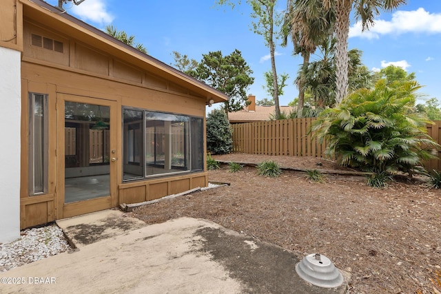 view of yard with a sunroom and fence